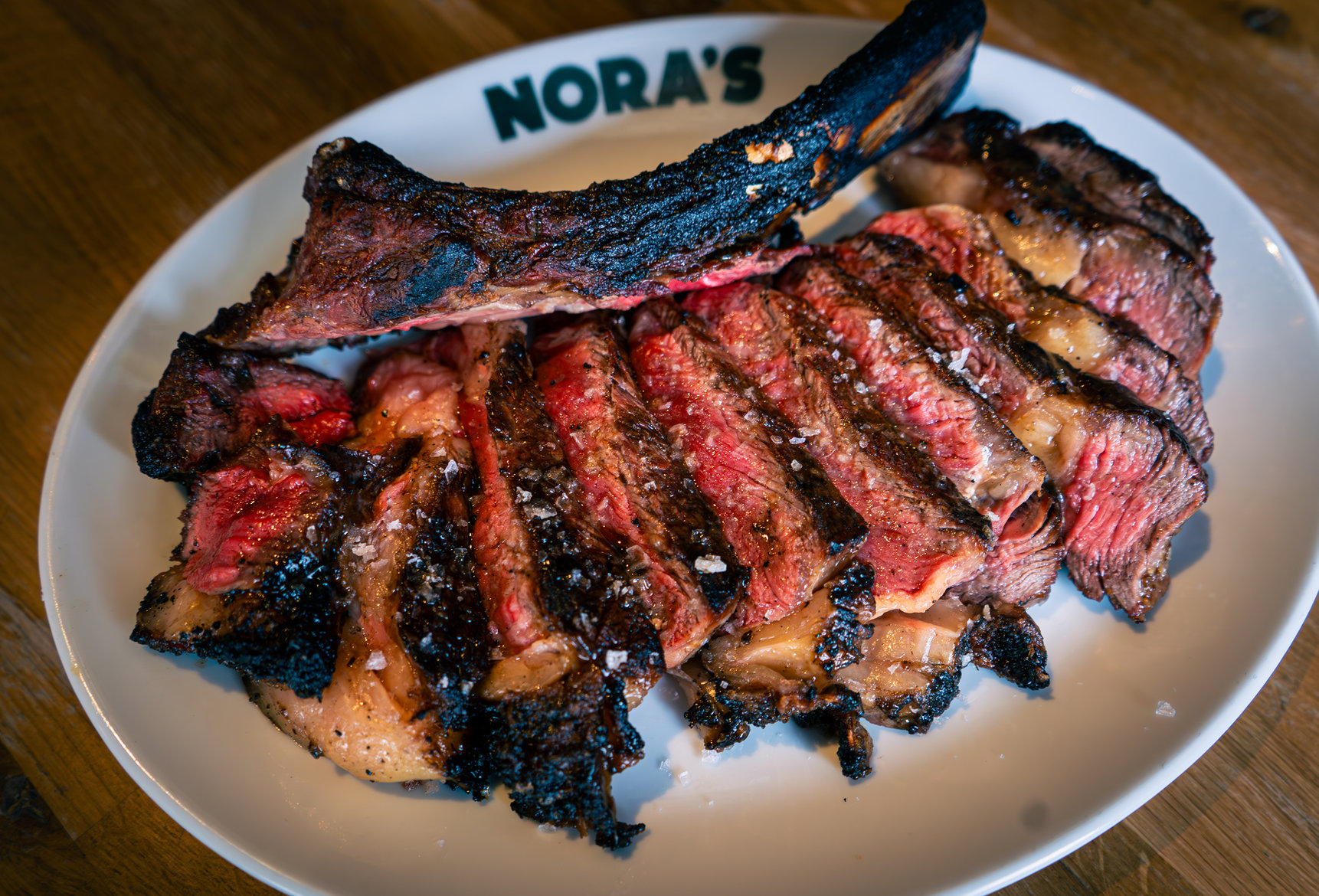 Sliced steak on a NORA'S plate
